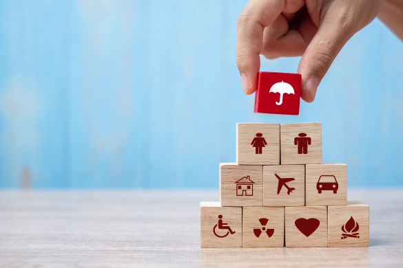 Building blocks with insurance icons in red